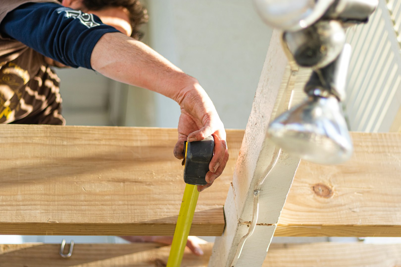 Carpenter using measuring tape